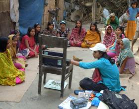 Description-Info Lady shows video to adolescent girls. Source-© 2012 Cassandra Mickish/CCP, Courtesy of Photoshare.