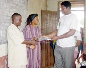 Man handing a box to a couple