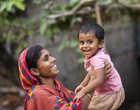 A woman holds her child. Source - SPRING/Bangladesh.  