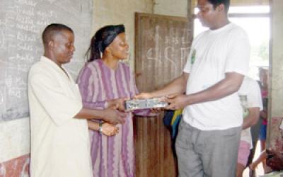 Man handing a box to a couple