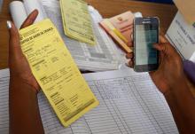 A health worker uses the mVacciNation mobile app to record vaccination data in Nampula, Mozambique.