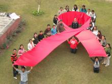 Students of the Department of Social Work at Panjab University make a red ribbon to mark World AIDS Day in Chandigarh, India.