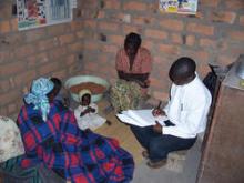 Man interviewing a family and taking notes